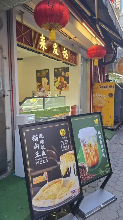 Asian Street Food Shop with Red Lanterns and Signage - stock photo