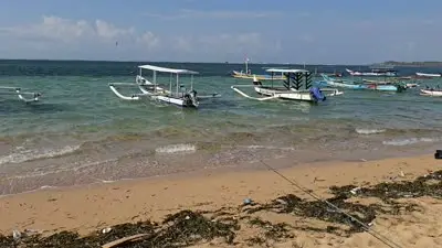 Bali Beach B-roll Footage: Traditional Jukung Boats on Pantai Bopel Shore - stock photo