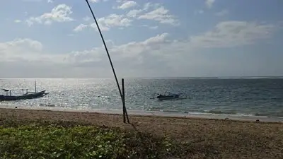 Bali Karang Beach B-Roll Footage: Coastal Path, Traditional Boats, and Tropical Garden - stock photo