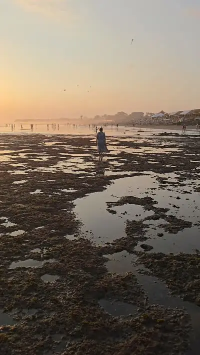 Bali Sunset Beach Low Tide B-roll Footage with People Walking - stock photo