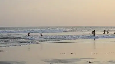 Bali Sunset Beach B-roll Footage with Silhouetted People and Surfers - stock photo