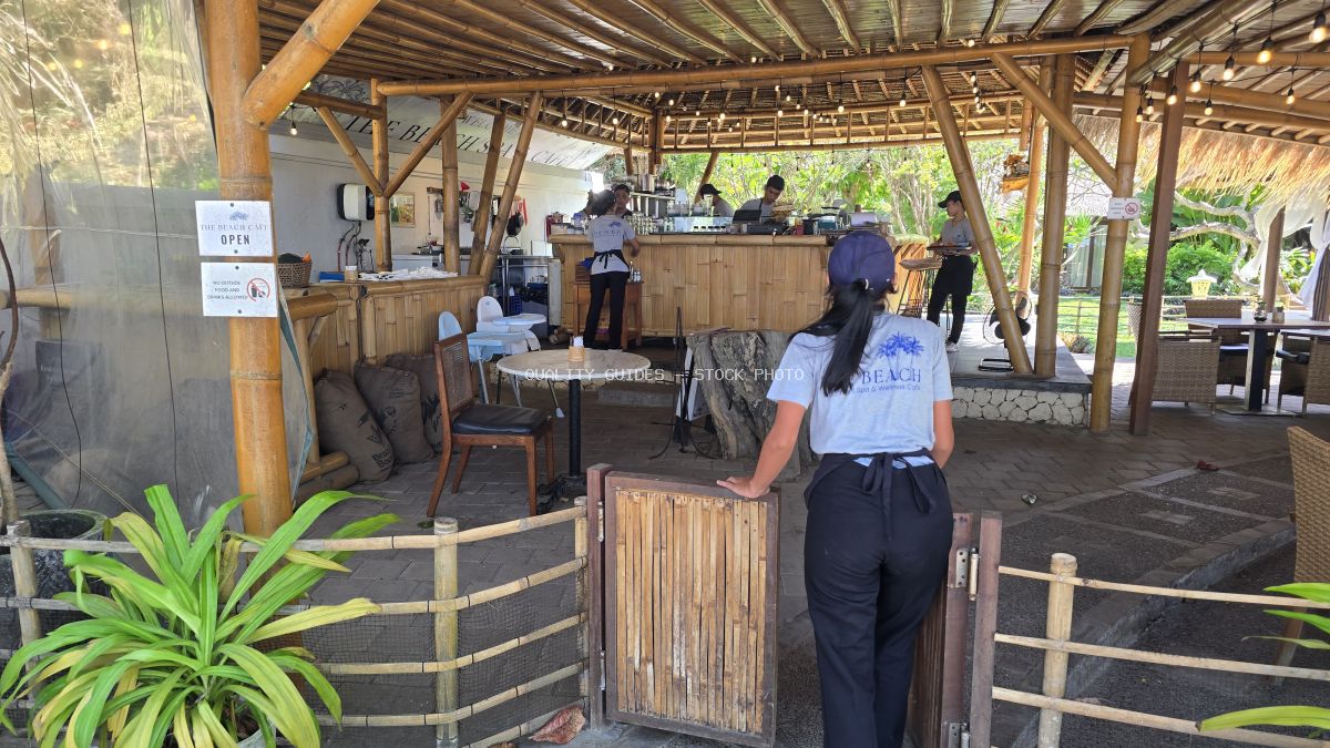 Staff working at a tropical bamboo cafe in Bali, 'The Beach Spa & Cafe' - stock photo