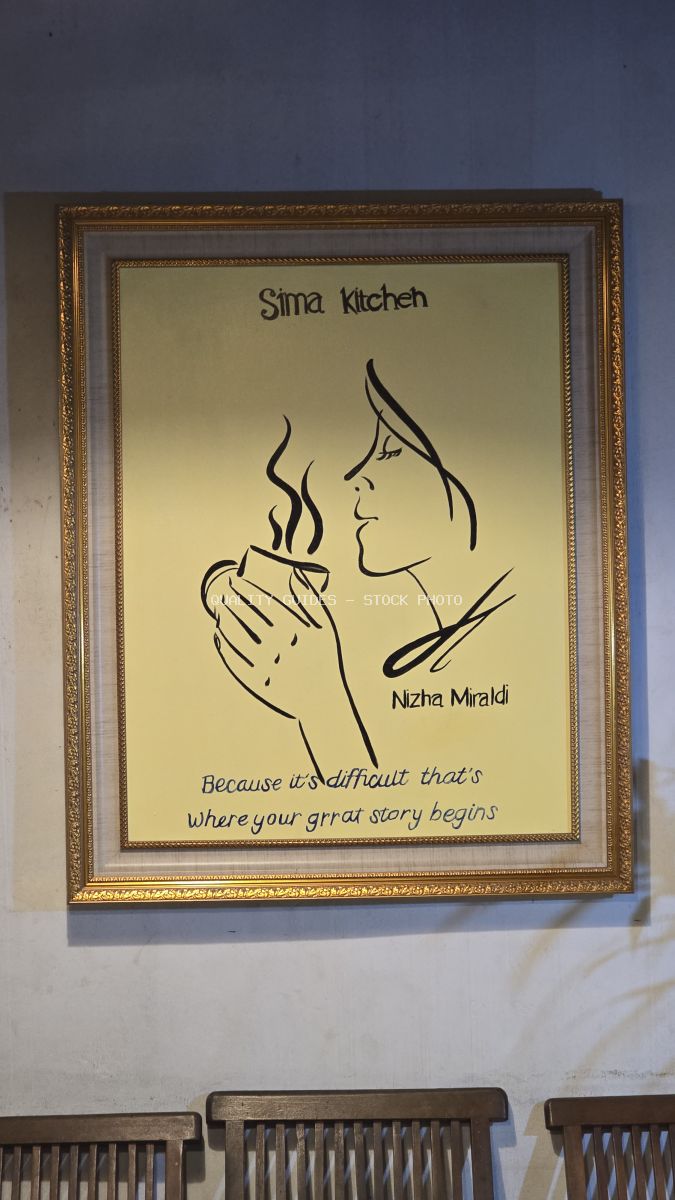 Framed line art of a woman with a steaming coffee cup and 'Sima Kitchen' text on a wall. - stock photo