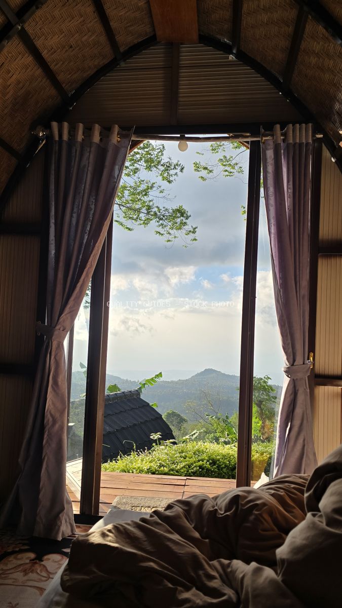 View from luxury glamping tent bed overlooking mountain landscape in Bali, Indonesia - stock photo