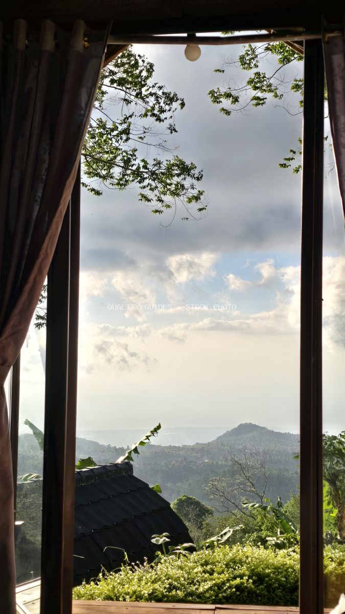 View from luxury glamping tent overlooking mountain landscape and tropical gardens in Bali - stock photo