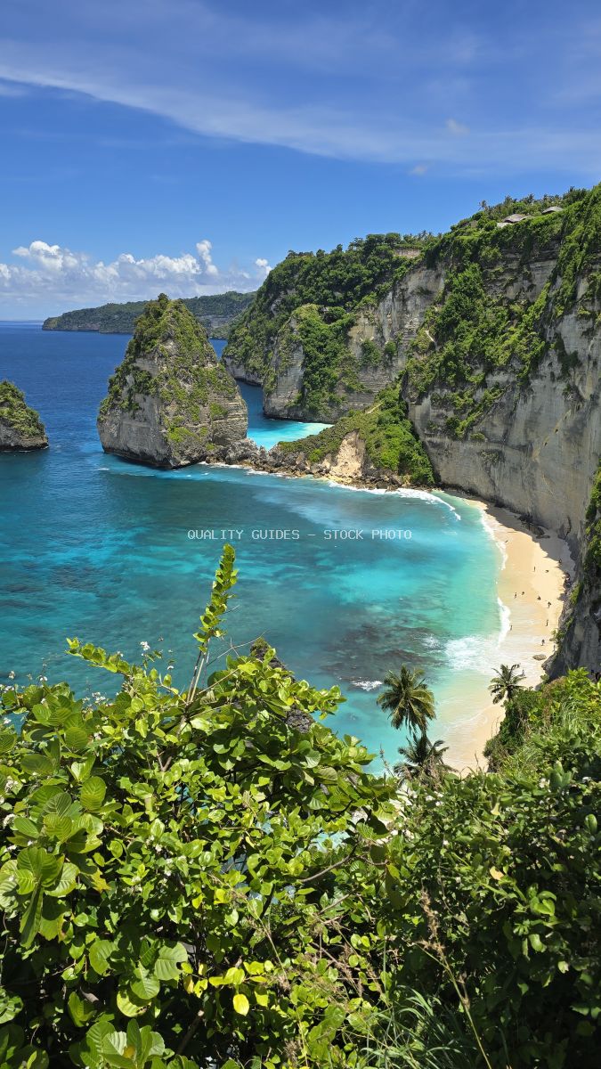 Aerial view of Diamond Beach Bali with turquoise waters, white sand, limestone cliffs, and tropical vegetation - stock photo
