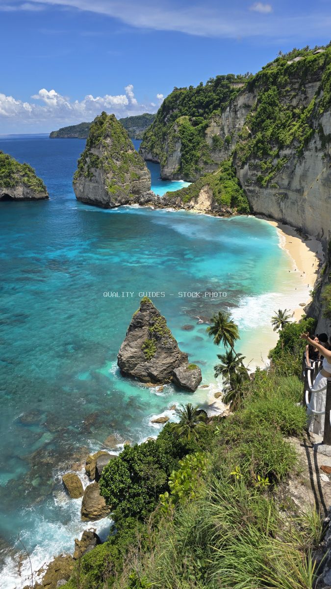 Aerial view of Diamond Beach Bali with turquoise waters, limestone cliffs, and white sand beach surrounded by tropical vegetation - stock photo