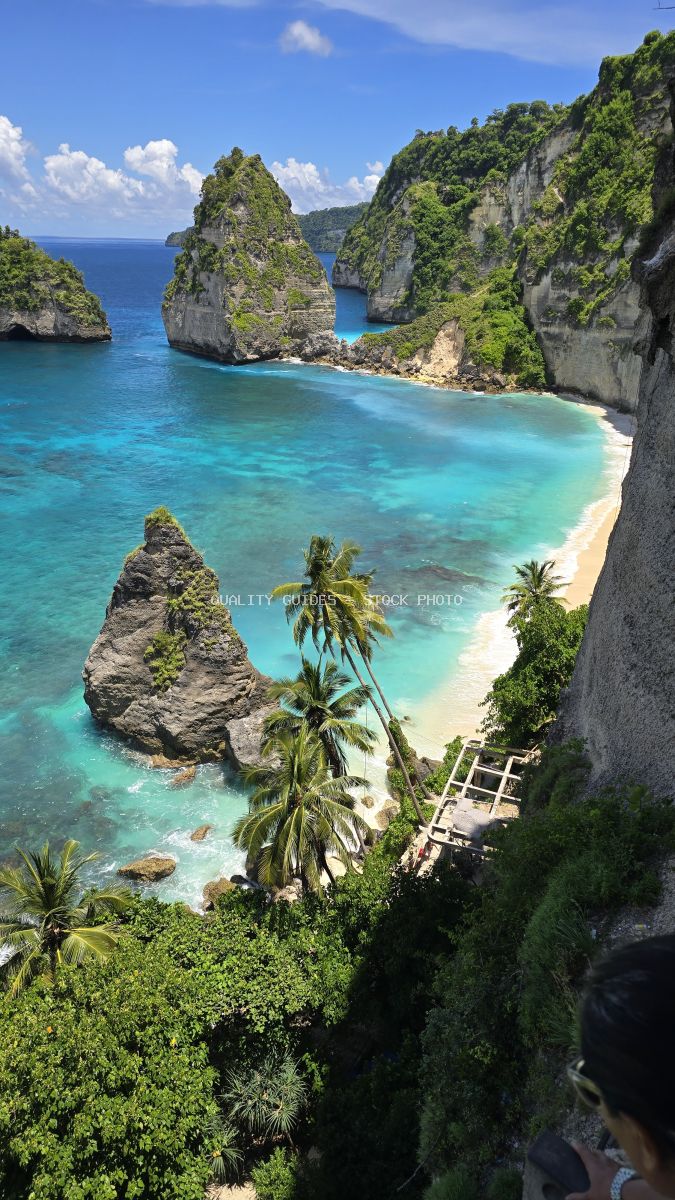 Aerial view of Diamond Beach Bali with turquoise lagoon, limestone cliffs, and tropical vegetation - stock photo