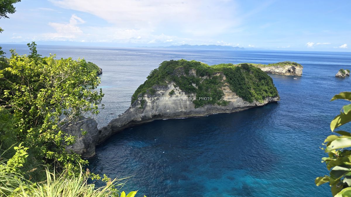 Aerial view of Diamond Beach Bali with limestone cliffs, turquoise ocean, and tropical vegetation - stock photo