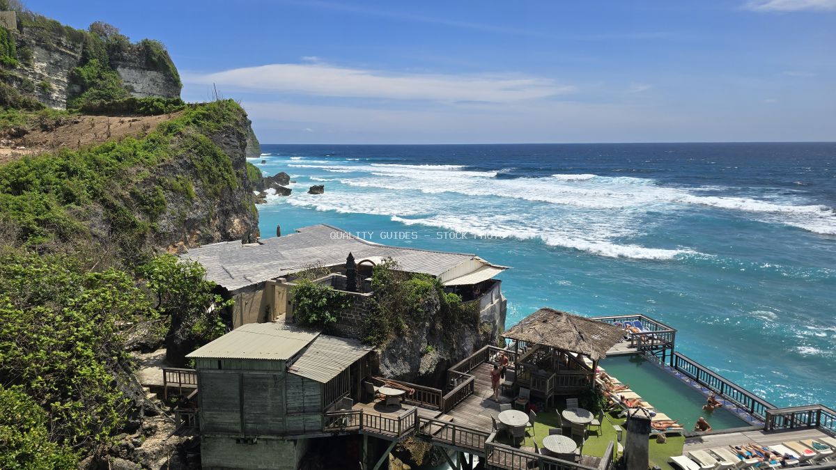 Aerial view of clifftop resort at Suluban-Uluwatu Beach in Bali with turquoise lagoon and ocean waves - stock photo