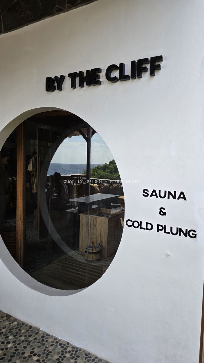 By The Cliff Bali sauna and cold plunge signage with circular window view of ocean - stock photo