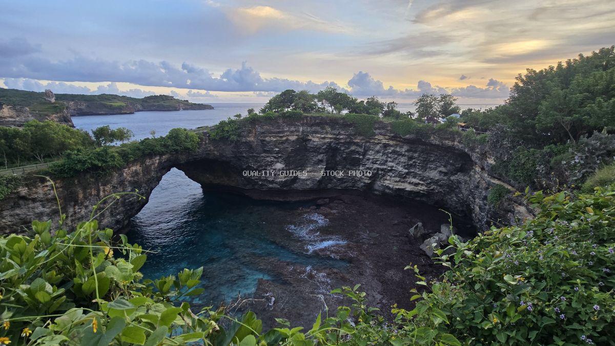 Broken Beach Bali with natural rock arch and turquoise waters surrounded by tropical vegetation - stock photo