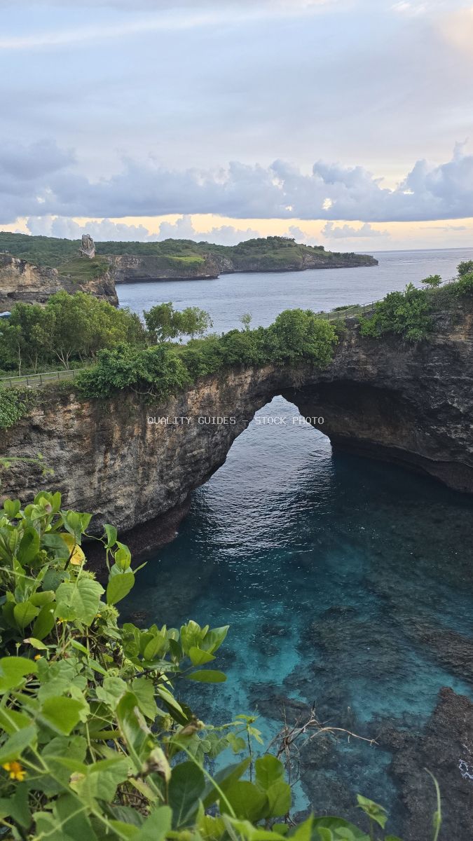 Broken Beach Bali natural rock arch with turquoise water and tropical vegetation - stock photo