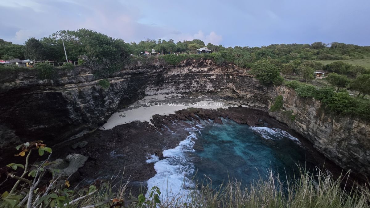 Aerial view of Broken Beach in Bali with turquoise waters, limestone cliffs, and natural arch formation - stock photo