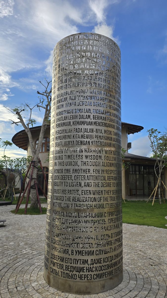Multilingual peace monument cylinder with carved text in multiple languages at Nuanu Creative City, Bali - stock photo