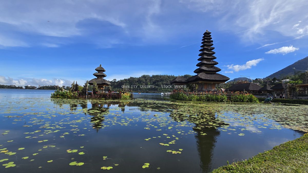 Ulun Danu Beratan Temple reflected in lake with lily pads, Bali Indonesia - stock photo