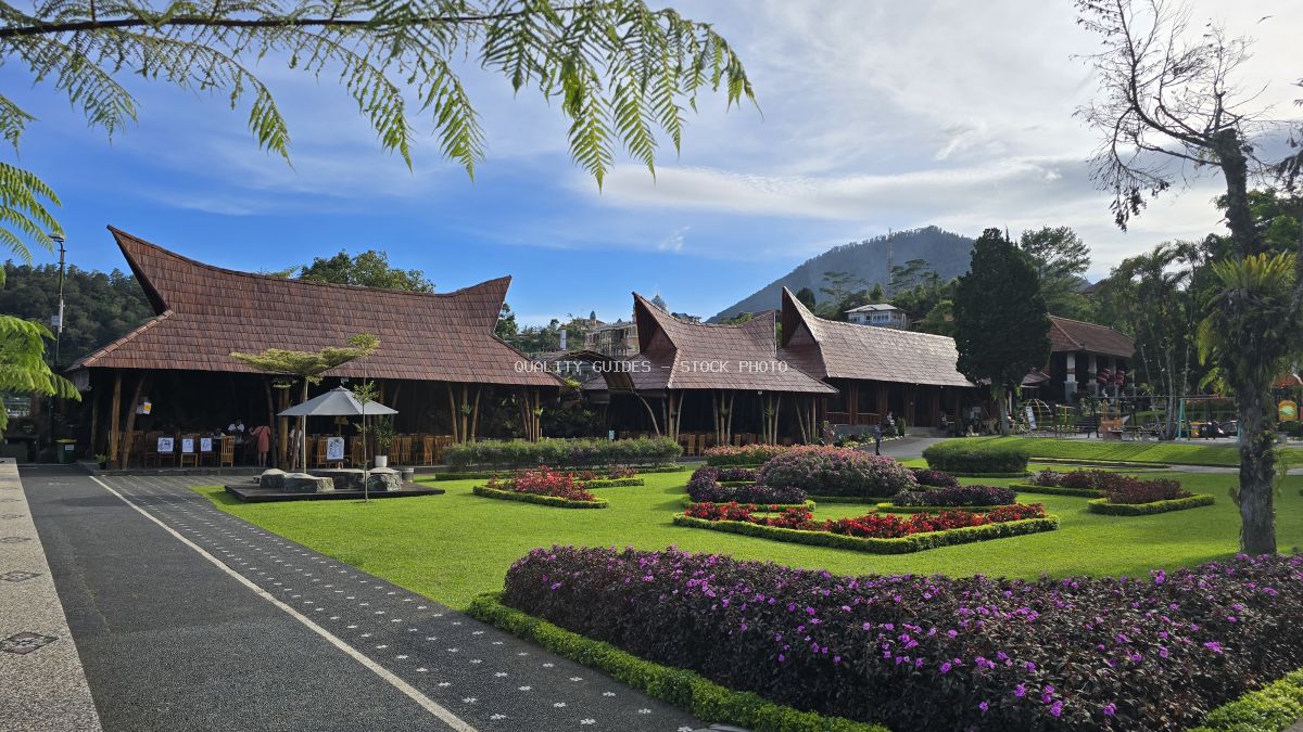 Ulun Danu Beratan Temple in Bali with traditional architecture, manicured gardens, and mountain backdrop - stock photo