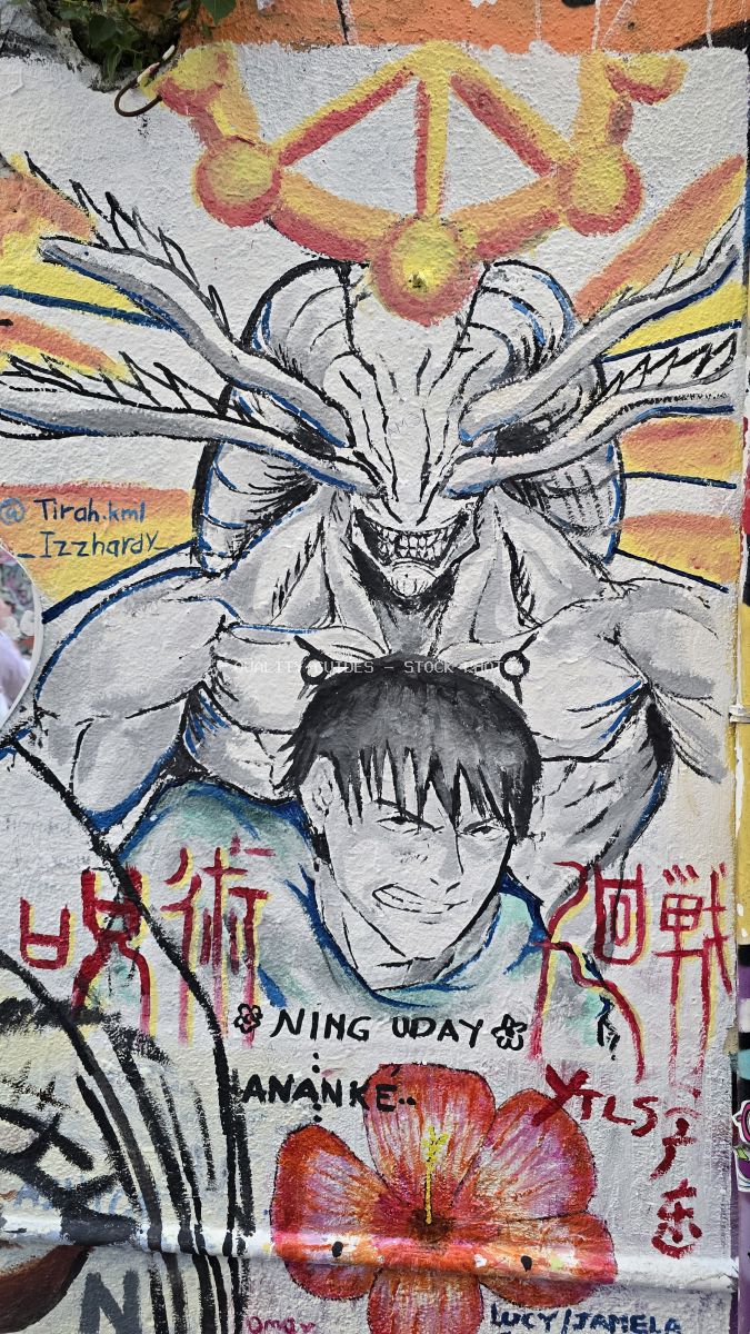 Colorful anime-inspired street art mural with demon character and Chinese text on brick wall at Kwai Chai Hong, Kuala Lumpur - stock photo