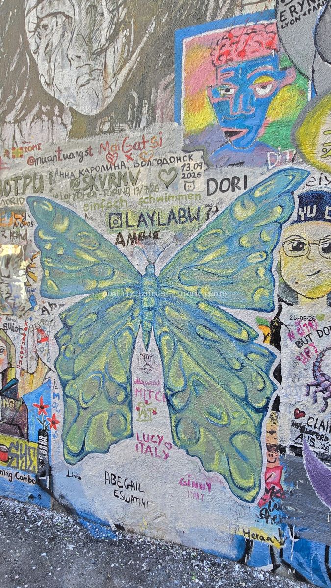 Turquoise and yellow butterfly street art mural surrounded by colorful graffiti and international signatures at Kwai Chai Hong in Kuala Lumpur - stock photo