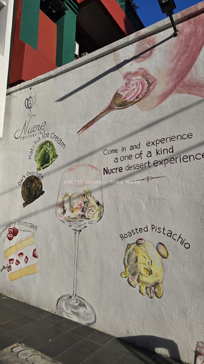 Colorful dessert mural on Kwai Chai Hong wall in Kuala Lumpur featuring Nucre ice cream and pastry illustrations - stock photo