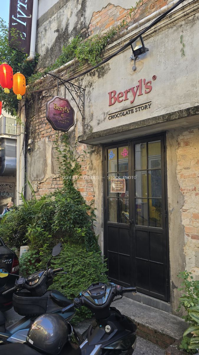 Beryl's Chocolate Story storefront with ivy-covered walls and lanterns in Kwai Chai Hong, Kuala Lumpur - stock photo
