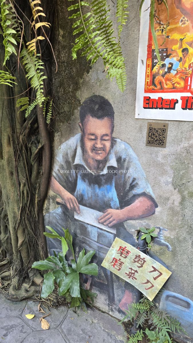 Street art mural of man with Asian characters surrounded by climbing ferns and ivy on concrete wall - stock photo